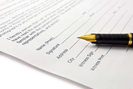 Closeup of ink pen signing signature in documentの写真素材