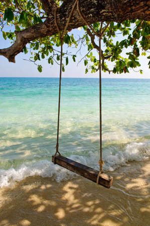 Swing on tropical sea beachの写真素材