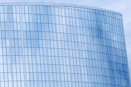 Glass wall of business center and sky reflectionの写真素材