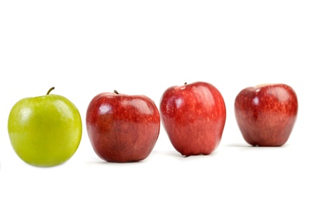 Ripe red apples and one green apple isolated on whiteの写真素材