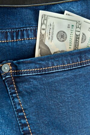 dollar bills in jeans pocket