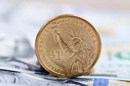 coin one dollar against the background US dollars backgroundの写真素材