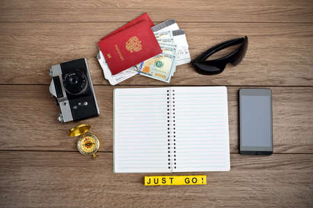 Retro style travel stuff on wooden tableの写真素材
