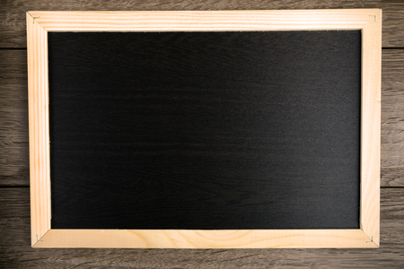 Blackboard on wooden backgroundの写真素材