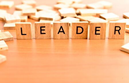Leader conceptual text on wooden tilesの写真素材