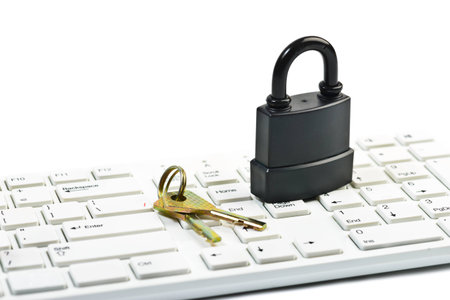 Data security concept with padlock and key on computer keyboard over white