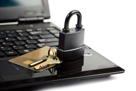 Data security concept with padlock key on laptop computer keyboard and credit card