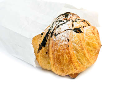Fresh croissant in package on white backgroundの写真素材