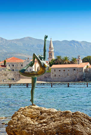 BUDVA, MONTENEGRO - SEPTEMBER 23, 2016: Dancing Girl Statue - an attractive sculpture and popular photo opportunity for tourists on background of old city Budva, Montenegro, Europeのeditorial素材