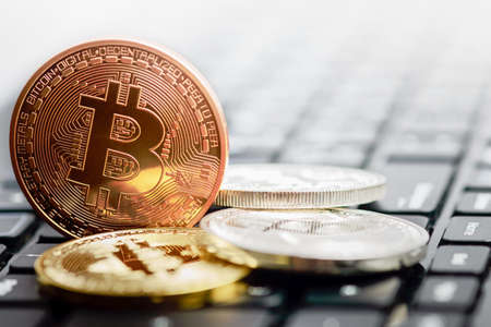 bitcoin coins on black keyboard background