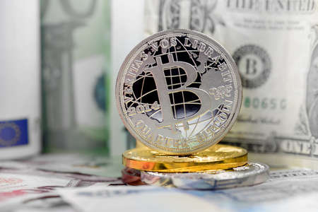 Bitcoin simbol over dollar and euro backgroundの写真素材