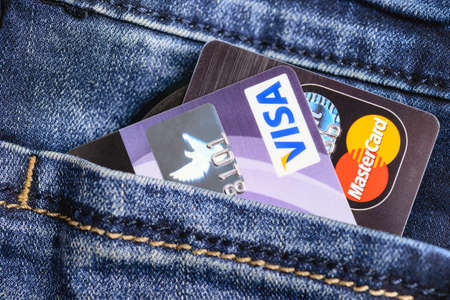 Moscow, Russia - August 05, 2017: Visa and Mastercard credit cards in blue jeans pocket