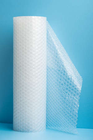 Roll of bubble wrap on blue backgroundの写真素材