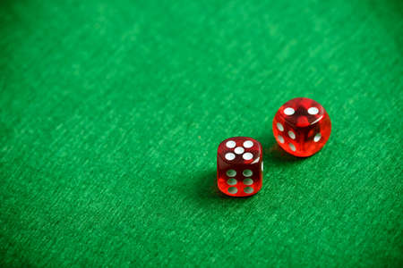 Red poker dices on casino table backgroundの写真素材