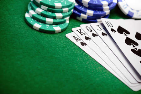 Poker chips and a straight flush card hand with copy space for your text
