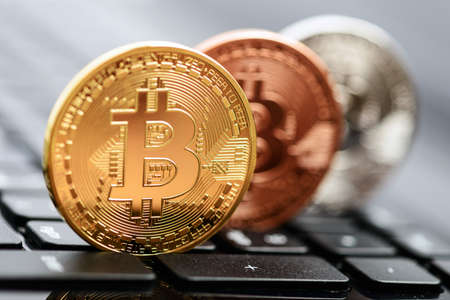 Photo bitcoins coins on notebook keyboard. Crypto currency concept