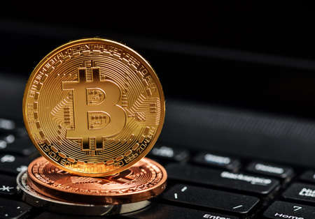 Photo bitcoins coins on notebook keyboard. Crypto currency concept