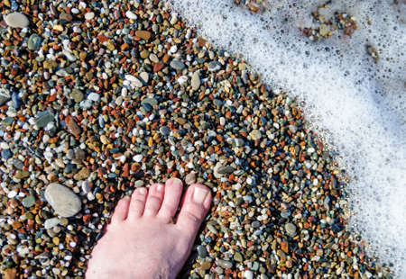 Vacation on sea beach, feet on sea sand,copy spaceの写真素材