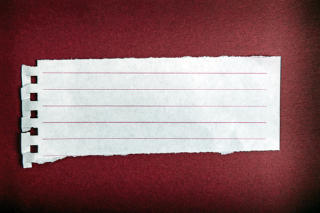 Turn notebook paper on dark red backgroundの写真素材