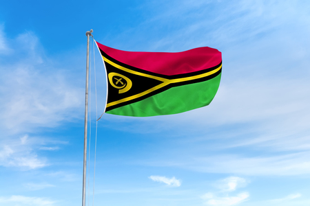 Vanuatu flag blowing in the wind over nice blue sky backgroundの写真素材