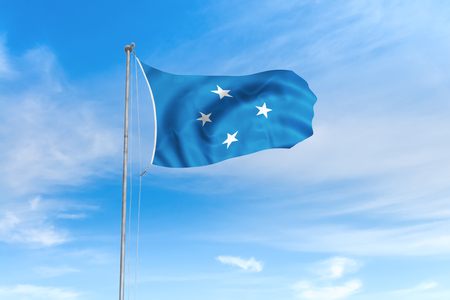 Federated States of Micronesia flag blowing in the wind over nice blue sky backgroundの写真素材