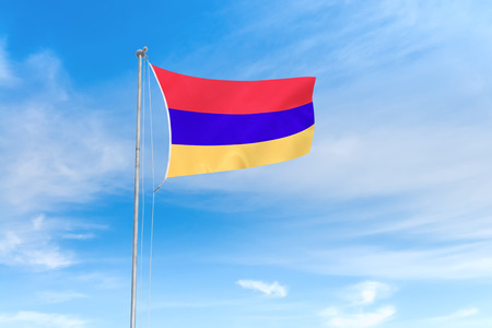Armenia flag blowing in the wind over nice blue sky backgroundの写真素材