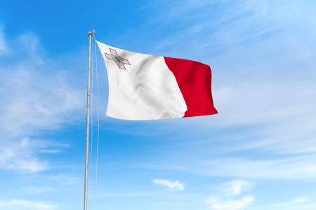 Malta flag blowing in the wind over nice blue sky backgroundの写真素材
