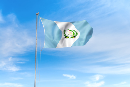 Guatemala flag blowing in the wind over nice blue sky backgroundの写真素材