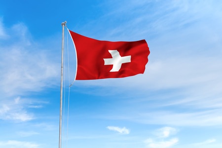 Switzerland Swiss flag blowing in the wind over nice blue sky backgroundの写真素材