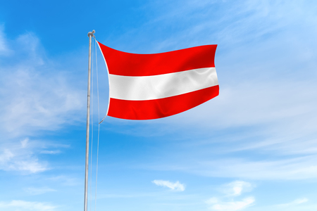Austria flag blowing in the wind over nice blue sky backgroundの写真素材
