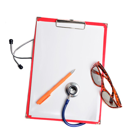 Stethoscope, pen and glasses on red clipboard cut out over white. Health care conceptの写真素材