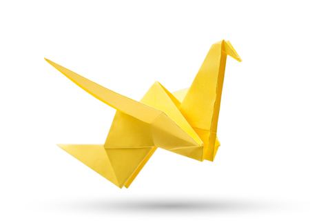 Origami flying bird isolated with clipping path. Japanese folded paper swan. Peace and hope symbolの写真素材