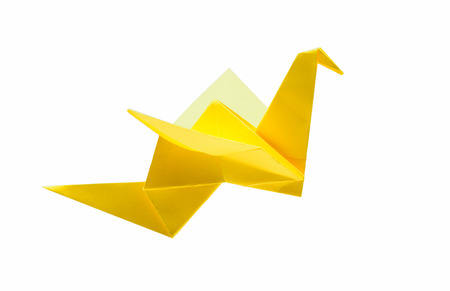 Origami flying bird isolated with clipping path. Japanese folded paper swan. Side viewの写真素材
