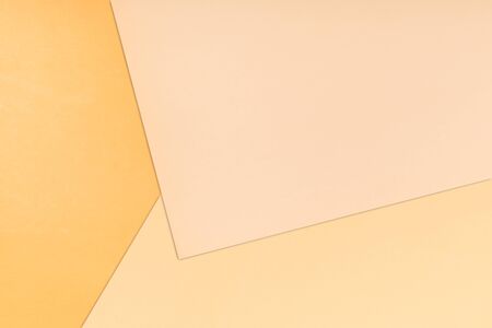 Paper color background. Three warm soft pastel peach color, yellow, light brown and pinkの写真素材