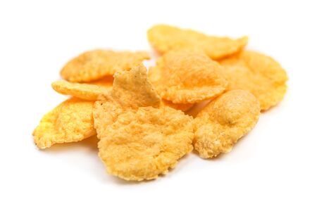 Cornflakes isolated macro. Small pile of corn flakes on white background