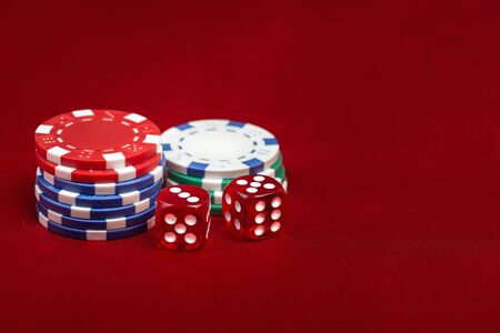 Dices and casino chps on red background. Gambling conceptの写真素材
