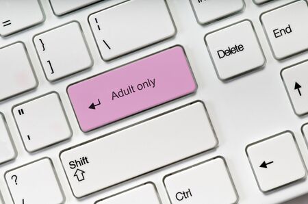 Adult only pink key button on white keyboard. Online sex concept