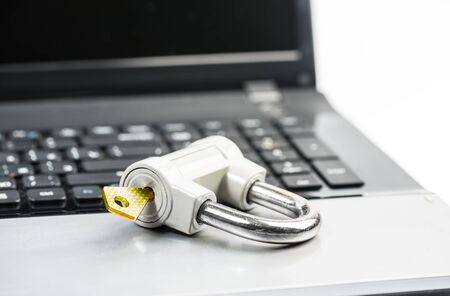 Computer security concept with a padlock on a laptop keyboard