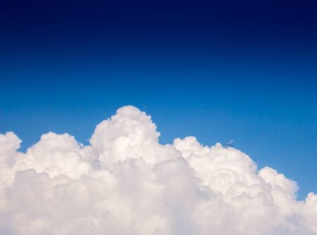 Large clouds on the background blue sky The aircraft appeared between the clouds and the sky.