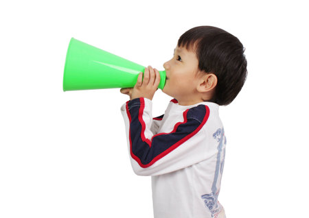 Young boy shouts into the megaphoneの写真素材