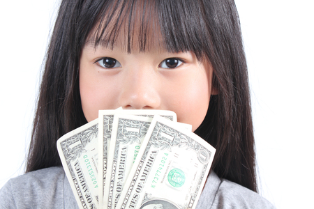 Cute girl holding moneyの写真素材