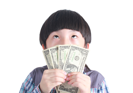 Young boy holding money on white background.の写真素材
