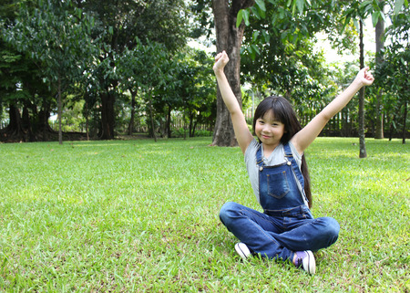 Portrait of young girl having a good time in the parkの写真素材