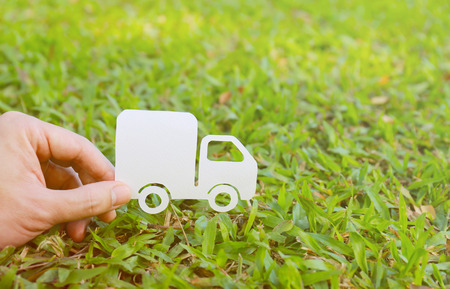 Paper cut of truck on green grass background, earth day concept, spring timeの写真素材