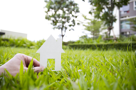 Green house concept. paper house on fresh grass land.の写真素材