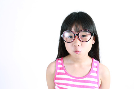 Close-up portrait of a pretty Asian girl wearing glassesの写真素材