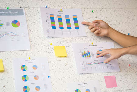 Hands pointing to strategy on the wallの写真素材