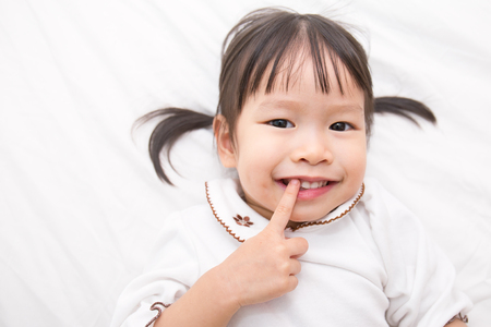 Adorable little asian girl wake up in her bed (girl, pretty)の写真素材