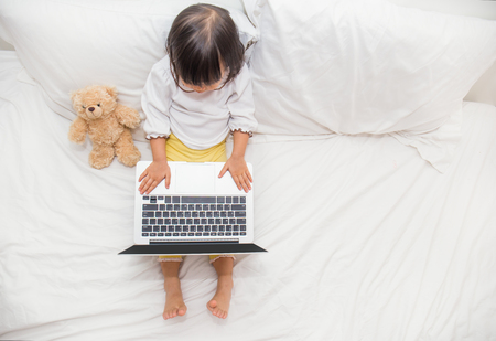 Top view of cute young girl using laptop with copy space .の写真素材