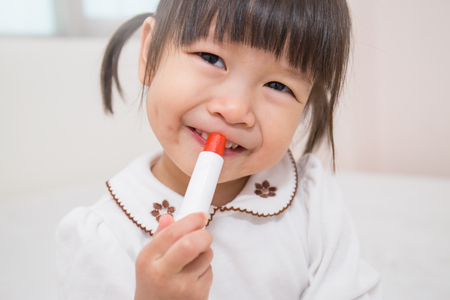 little girl with lipstick - make up (girl, child)の写真素材